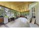 Enclosed sun room filled with natural light, wood ceiling, large windows, and a view of the lush exterior at 604 Longstreet St, Summerville, SC 29486