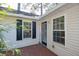 Charming back porch with dark shutters, wood floors, and inviting entrance; creates a cozy, private outdoor space at 642 Bridlewood Ln, Mount Pleasant, SC 29464