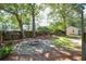 Beautiful backyard with a stone fire pit surrounded by mature trees at 642 Bridlewood Ln, Mount Pleasant, SC 29464