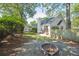 Inviting backyard with stone fire pit, string lights, and lush landscaping at 642 Bridlewood Ln, Mount Pleasant, SC 29464