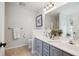 Bright bathroom features a double sink vanity, tiled floors, and updated fixtures at 642 Bridlewood Ln, Mount Pleasant, SC 29464
