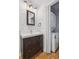 Bathroom with dark vanity cabinet, white toilet and stacked washer/dryer at 642 Bridlewood Ln, Mount Pleasant, SC 29464