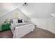 Bright bedroom with sloped ceiling, wainscoting, a window, and a vibrant green nightstand at 642 Bridlewood Ln, Mount Pleasant, SC 29464