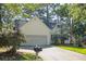 Traditional-style home featuring a driveway, lawn, mailbox, and mature trees at 642 Bridlewood Ln, Mount Pleasant, SC 29464