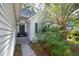 Inviting front entrance with a dark-colored door, blue potted plants, and lush tropical greenery at 642 Bridlewood Ln, Mount Pleasant, SC 29464