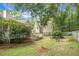 Backyard featuring a wooden deck, lush greenery, and patio seating area at 652 Spinner Cir, Mount Pleasant, SC 29464