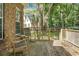 View of wooden deck in backyard surrounded by lush trees and a neighboring house at 652 Spinner Cir, Mount Pleasant, SC 29464