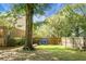 Fenced backyard featuring a large shade tree, lush green lawn, and storage at 652 Spinner Cir, Mount Pleasant, SC 29464