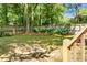 A peaceful backyard featuring a wooden fence and landscaped with vibrant hydrangeas under mature trees at 652 Spinner Cir, Mount Pleasant, SC 29464