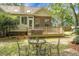 Backyard featuring a wooden deck, wrought iron furniture, and brick exterior at 652 Spinner Cir, Mount Pleasant, SC 29464