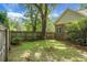 Backyard featuring a wooden fence, large tree, and well-maintained lawn at 652 Spinner Cir, Mount Pleasant, SC 29464