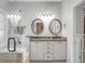 Bathroom with double sinks, granite counters, decorative mirrors and neutral paint at 652 Spinner Cir, Mount Pleasant, SC 29464