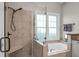 Bathroom featuring tiled stand up shower and large tub with window view at 652 Spinner Cir, Mount Pleasant, SC 29464