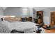 This bedroom has neutral-toned walls, hardwood floors, a queen bed, desk, and an exercise bike at 652 Spinner Cir, Mount Pleasant, SC 29464