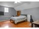 A spacious bedroom featuring a queen bed, hardwood floors, natural light and neutral colored walls at 652 Spinner Cir, Mount Pleasant, SC 29464