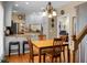 Dining area with wooden floors, table, and chairs, with a view of the kitchen and stairs at 652 Spinner Cir, Mount Pleasant, SC 29464