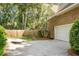 Paved driveway leading to a two-car garage, surrounded by lush landscaping at 652 Spinner Cir, Mount Pleasant, SC 29464