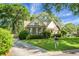 Charming home with brick facade and well-manicured lawn is complemented by mature trees and inviting curb appeal at 652 Spinner Cir, Mount Pleasant, SC 29464
