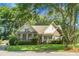 Charming home featuring a brick facade, well-manicured lawn, and mature trees, creating an inviting curb appeal at 652 Spinner Cir, Mount Pleasant, SC 29464