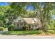 Charming single Gathering home featuring a brick facade, well-manicured lawn, mature trees, and inviting curb appeal at 652 Spinner Cir, Mount Pleasant, SC 29464