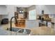 Open kitchen area with island, stainless steel appliances, and views of the dining area and staircase at 652 Spinner Cir, Mount Pleasant, SC 29464