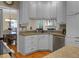 White kitchen cabinetry, hardwood floors and granite counters with dining area in the background at 652 Spinner Cir, Mount Pleasant, SC 29464
