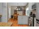 Kitchen area featuring stainless steel appliances, an island and a dining area with view of the staircase at 652 Spinner Cir, Mount Pleasant, SC 29464