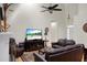 Bright living room with a high ceiling, ceiling fan, and a large leather sofa at 652 Spinner Cir, Mount Pleasant, SC 29464