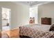 Main bedroom with hardwood flooring, adjacent bath, desk area, and natural light at 652 Spinner Cir, Mount Pleasant, SC 29464