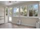 A sunroom with tile flooring, expansive windows viewing greenery, and a door to an outside deck at 652 Spinner Cir, Mount Pleasant, SC 29464
