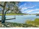 Scenic waterfront with a dock, lush marshland, and beautiful trees under a partly cloudy sky at 652 Spinner Cir, Mount Pleasant, SC 29464