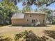 Exterior view of the rear of a two-story home, including a backyard with lush trees at 702 Spark St, Mount Pleasant, SC 29464
