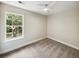 Bedroom view with a window providing natural light, complemented by neutral carpet and walls at 702 Spark St, Mount Pleasant, SC 29464