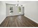 An empty dining room with natural lighting showcases hardwood floors and views of the surrounding neighborhood at 702 Spark St, Mount Pleasant, SC 29464