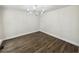 A spacious dining room with hardwood floors, decorative lighting, and neutral walls at 702 Spark St, Mount Pleasant, SC 29464