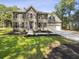 Charming two-story home with landscaped front yard, concrete driveway, and attached two-car garage at 702 Spark St, Mount Pleasant, SC 29464