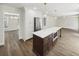 Kitchen view showcasing stainless steel appliances, a center island, and modern lighting fixtures at 702 Spark St, Mount Pleasant, SC 29464