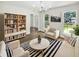 Bright living room featuring hardwood floors, a striped rug, neutral furniture, and natural light at 702 Spark St, Mount Pleasant, SC 29464
