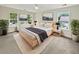Bright main bedroom with two windows, neutral walls and carpet, and contemporary decor at 702 Spark St, Mount Pleasant, SC 29464