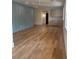 Open-concept living room with stylish wood floors, blue accent wall, and ample natural light at 758 Mccants Dr, Mount Pleasant, SC 29464