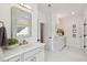 Bright bathroom featuring white vanities, framed mirrors, and modern fixtures at 766 Maynard Ln, Summerville, SC 29486