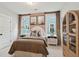 Cozy bedroom featuring a large bed, stylish nightstands, and two windows showcasing a bright exterior at 766 Maynard Ln, Summerville, SC 29486