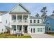 Charming two-story home boasts a light blue exterior, a welcoming front porch, and a second-story balcony at 766 Maynard Ln, Summerville, SC 29486