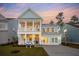Stunning two-story home with a welcoming front porch and balcony, featuring light blue siding and white trim at 766 Maynard Ln, Summerville, SC 29486