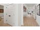 Well-lit hallway with hardwood floors, closet space, and an open view into the dining area at 766 Maynard Ln, Summerville, SC 29486