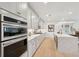 Modern kitchen with stainless steel appliances, a large center island and sleek white cabinetry at 766 Maynard Ln, Summerville, SC 29486
