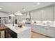 Stylish kitchen with white cabinets, marble countertops, a spacious island, and pendant lighting at 766 Maynard Ln, Summerville, SC 29486