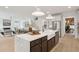 Open kitchen featuring a large island with seating and a view to the living room and staircase at 766 Maynard Ln, Summerville, SC 29486