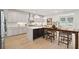 Bright, modern kitchen with white cabinets, large island and a warm wood dining table at 766 Maynard Ln, Summerville, SC 29486