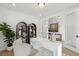 Bright home office with a unique desk, built-in shelving, and a view through glass doors to the hallway at 766 Maynard Ln, Summerville, SC 29486
